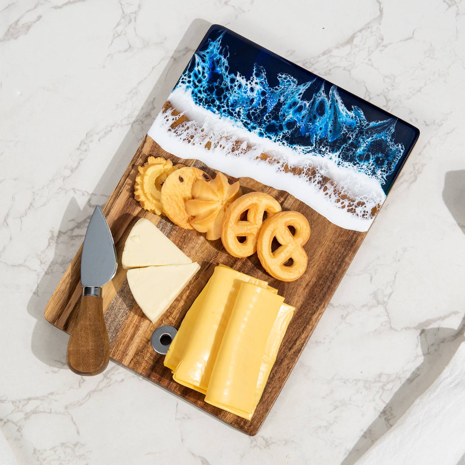Small acacia wood and epoxy resin cheese board for fruit bread appetizers and compact serving