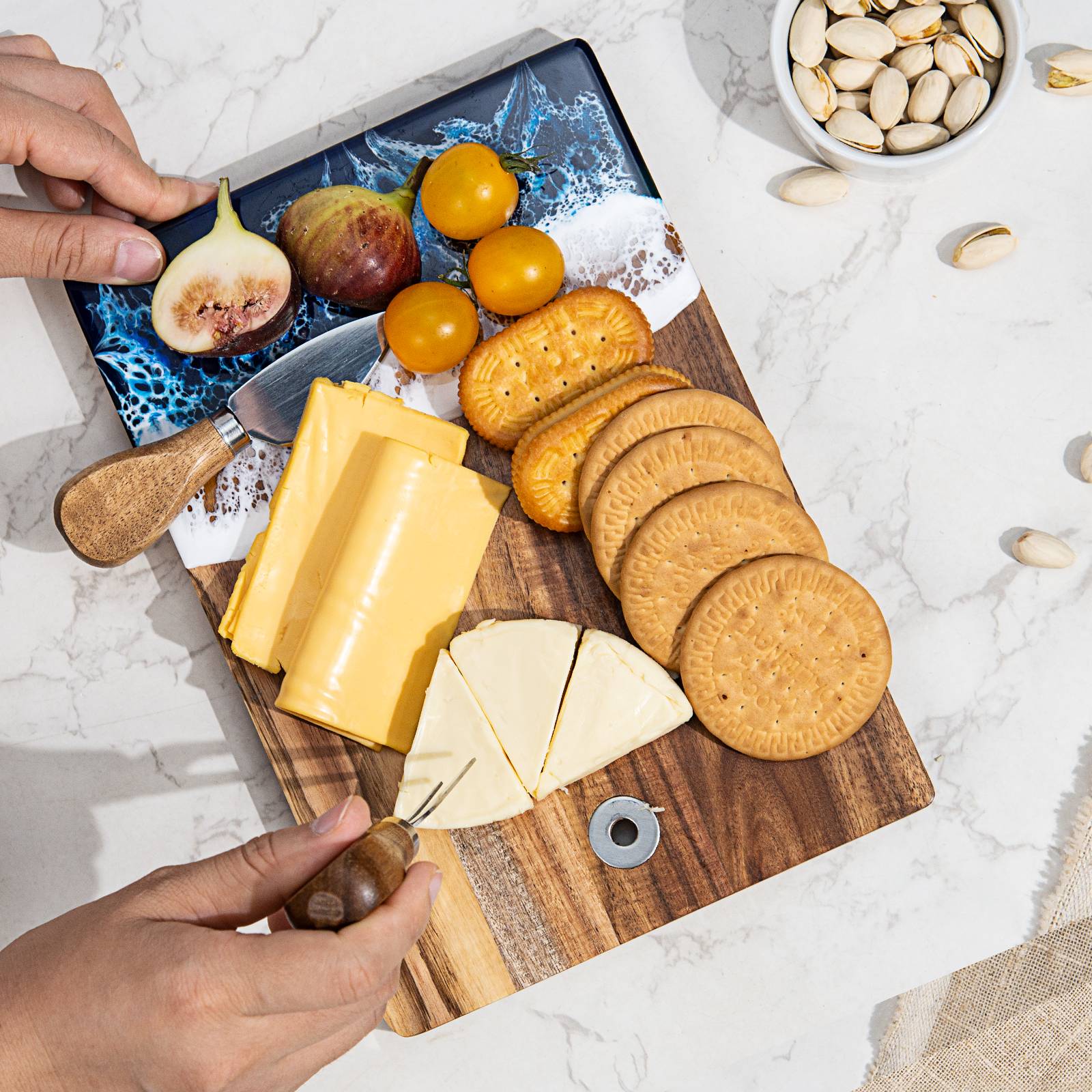 Small acacia wood and epoxy resin cheese board for fruit bread appetizers and compact serving