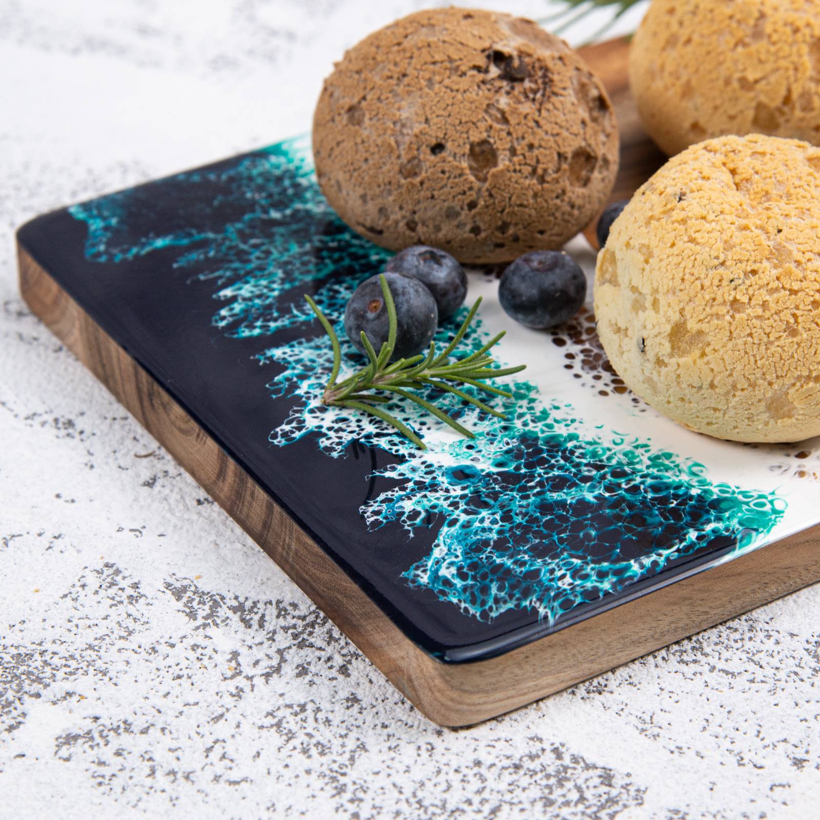 Small acacia wood and epoxy resin cheese board for fruit bread appetizers and compact serving