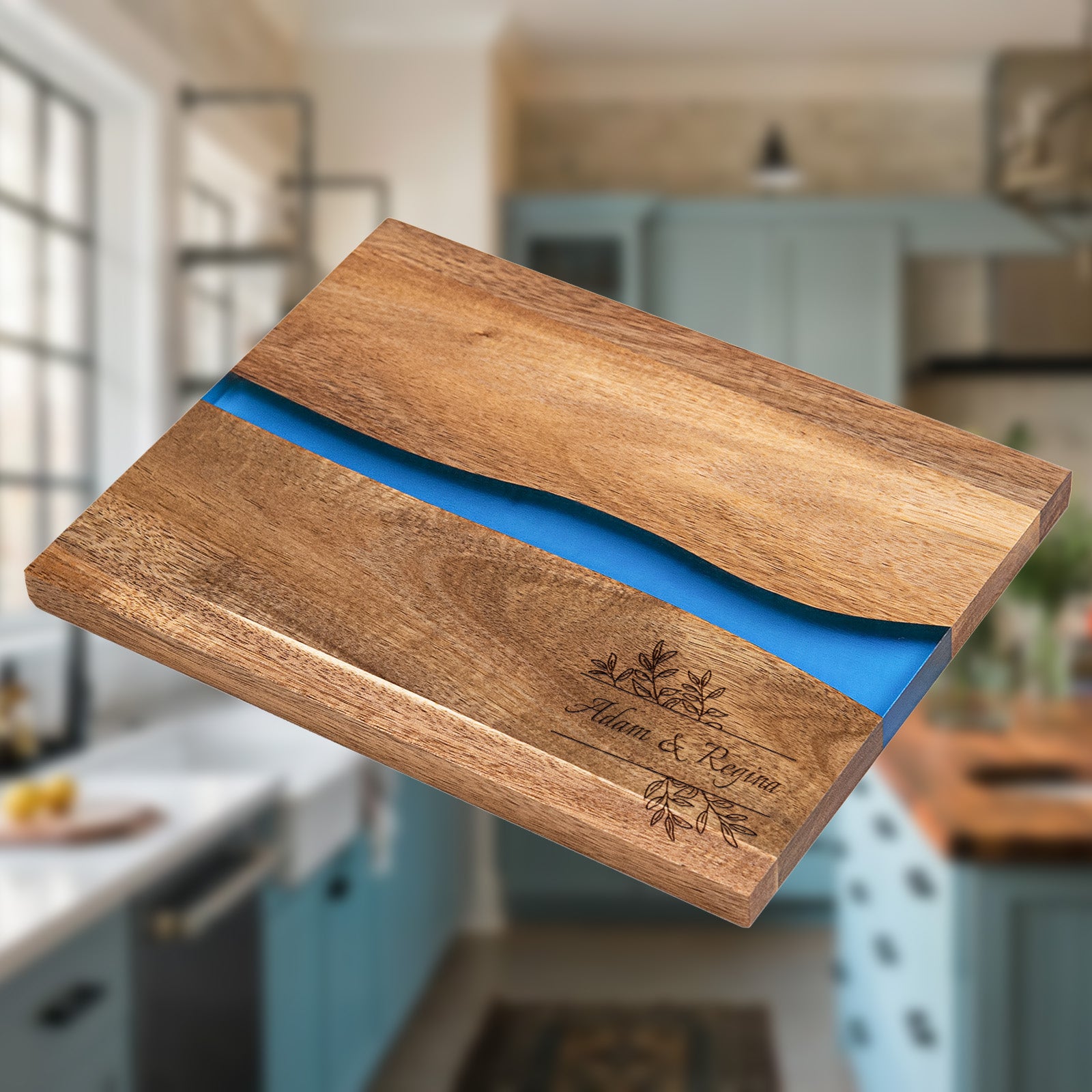 Personalized epoxy resin cutting board engraved with The Royston Family in script font on acacia wood with blue river resin inlay