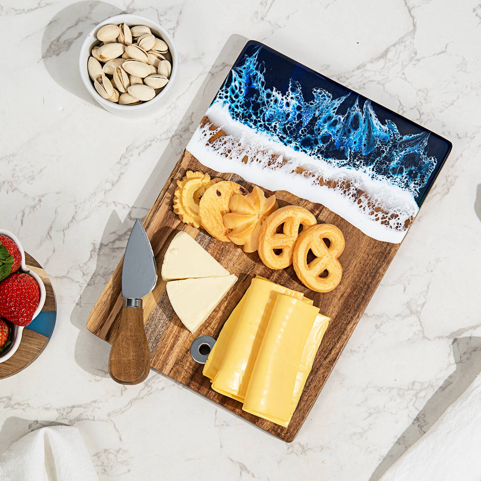Small acacia wood and epoxy resin cheese board for fruit bread appetizers and compact serving