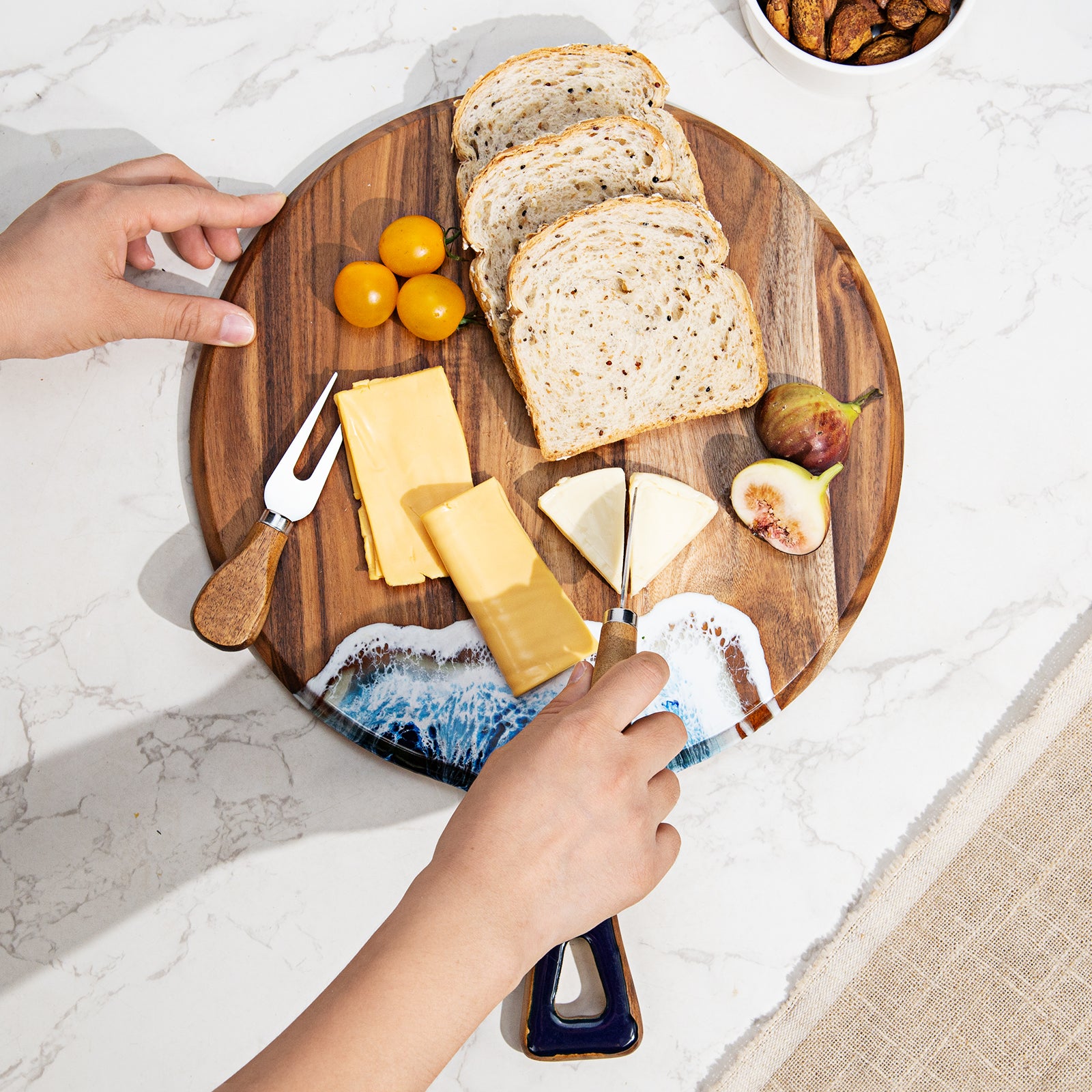 Round acacia wood and epoxy resin charcuterie board for cheese fruit desserts and ocean style serving
