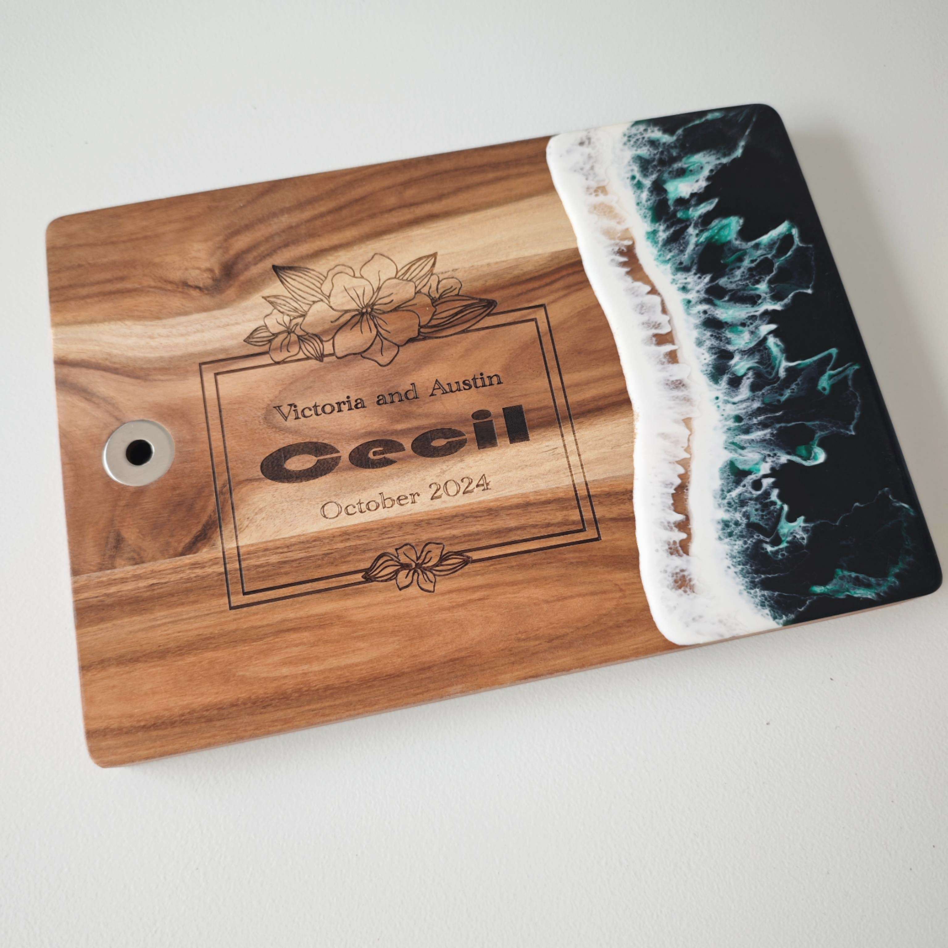 Wood and resin cutting board with handle shown from top-down angle